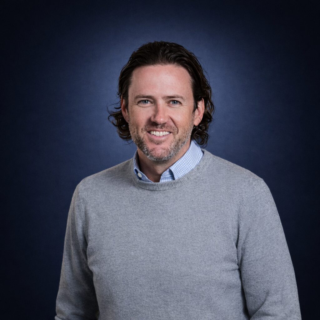 Scott Stanford headshot navy background